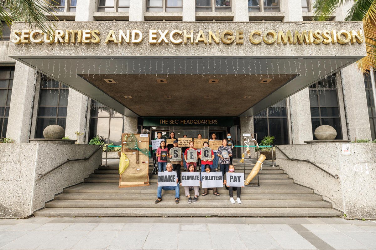 Typhoon survivors from Salcedo, Eastern Samar, delivered a letter to the SEC office in Makati, urging stricter climate accountability for corporations. Marking 11 years since Haiyan, they brought 11 ruined items as symbols of their loss. [Photo by Jilson Tiu | Greenpeace]