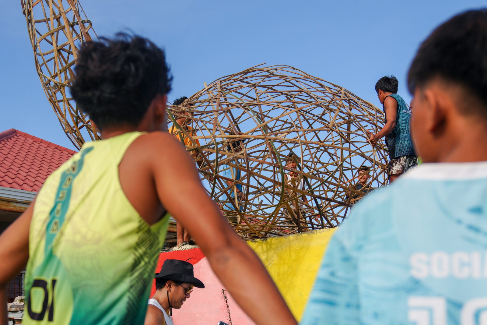 Fragments of homes and fishing tools are woven into the artwork, symbolizing resilience and memory. [photo credit: Greenpeace]